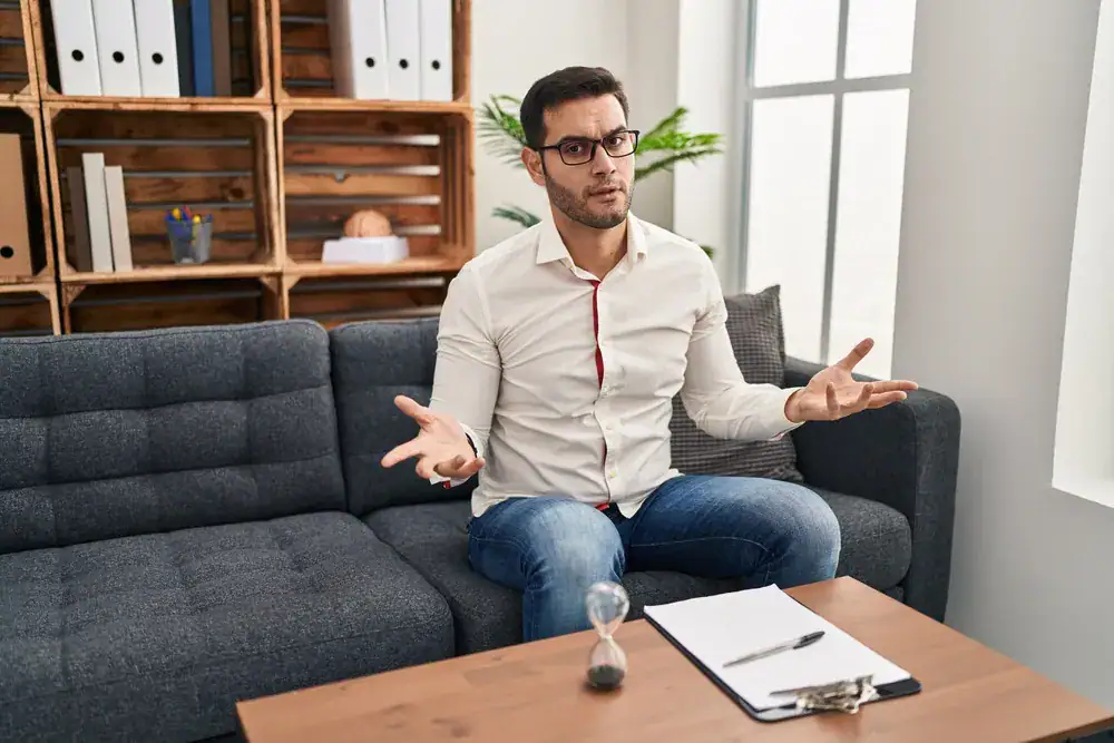 Man discussing mental health in a therapy session.